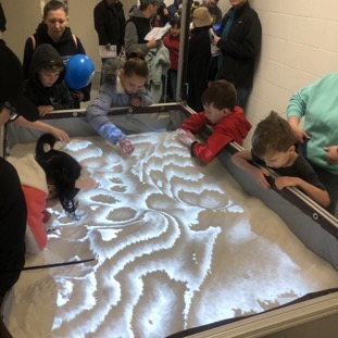More kids playing in the AR Sandbox