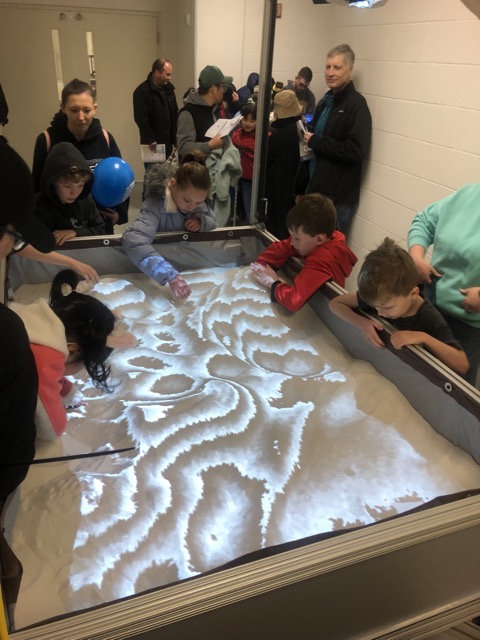 More kids playing in the AR Sandbox